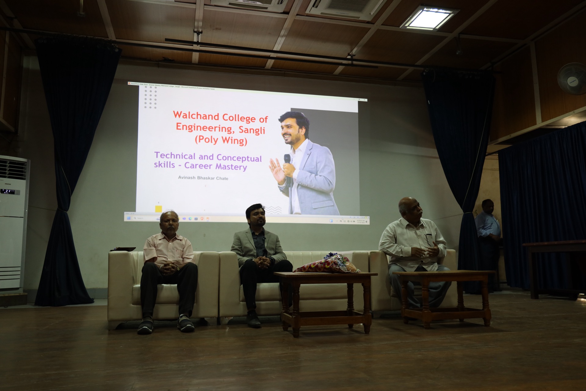 The title slide reading “Walchand College of Engineering, Sangli — Technical and Conceptual skills, Career Mastery, Avinash Bhaskar Chate” projected above Avinash Chate seated on stage with two faculty members