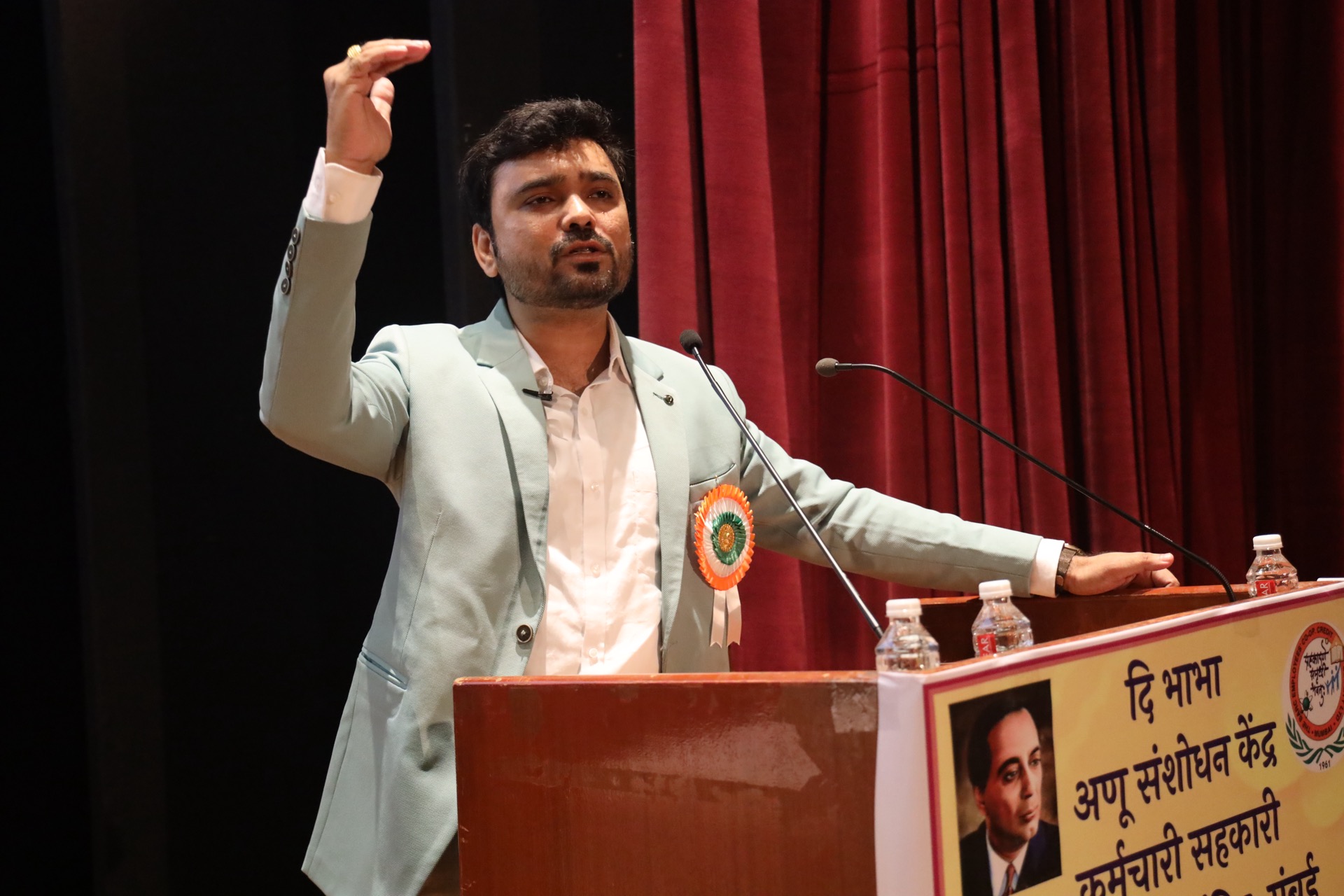 Avinash Chate, wearing the welcome rosette, addressing members of the Bhabha Atomic Research Centre employees’ co-operative society from the podium, Mumbai